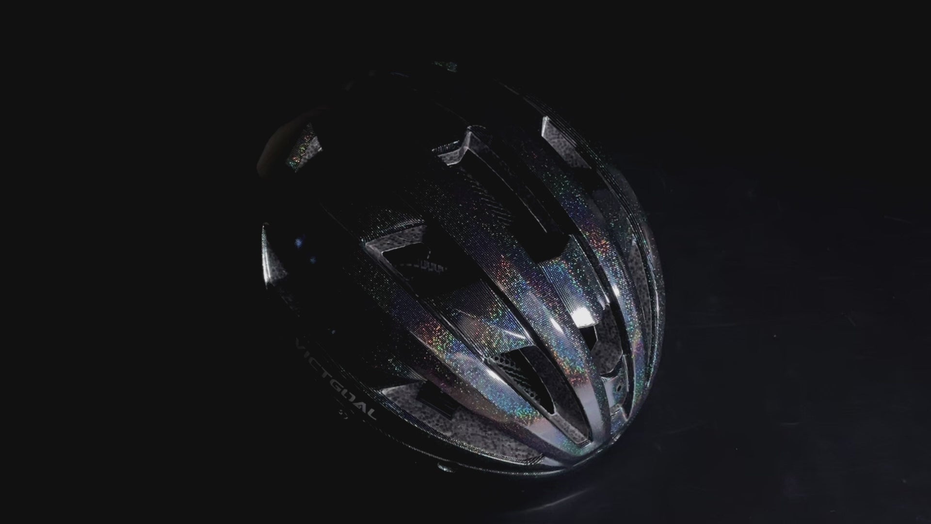 Black GLITTER road bike helmet with reflective finish under studio lighting