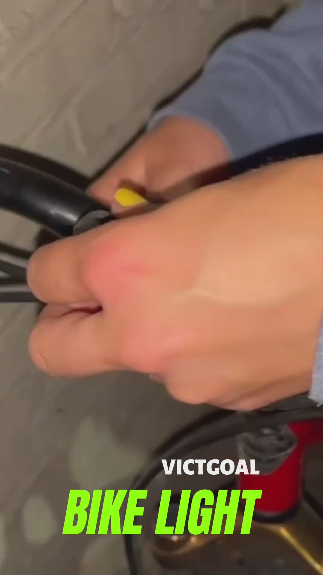 Close-up of a rider fastening the 2-in-1 bike light to a mounting strap