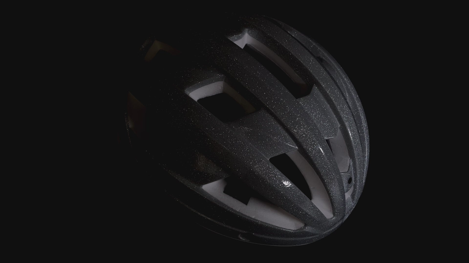 Matte black GLITTER road bike helmet shown from the side under studio lighting