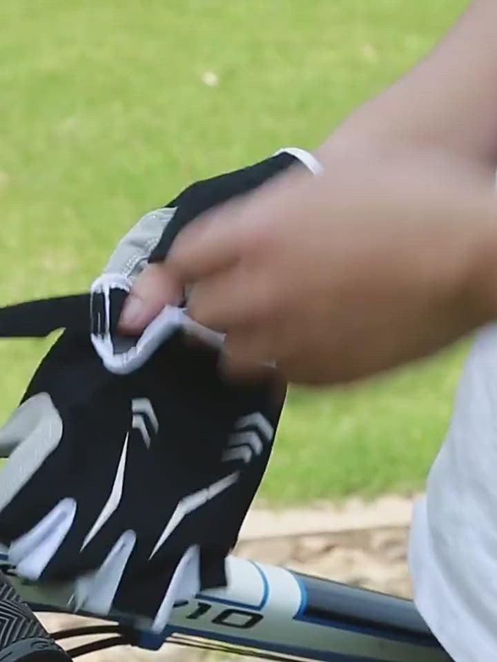 Rider adjusting a padded half-finger cycling glove outdoors